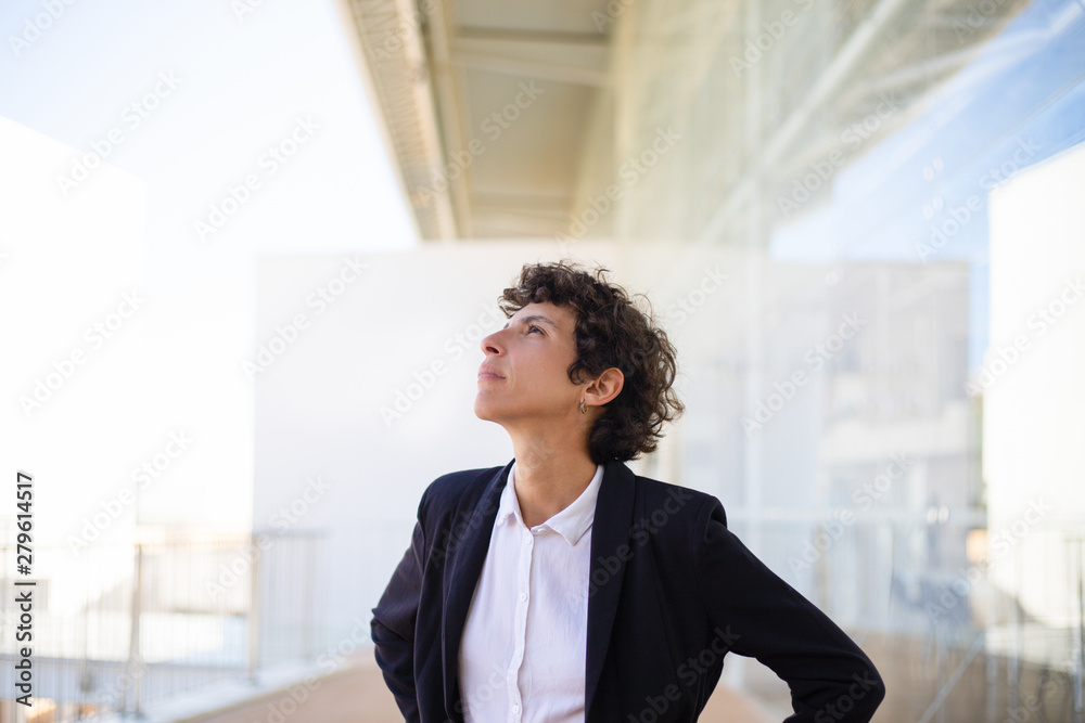 Pensive woman in formal wear looking aside. Beautiful thoughtful businesswoman standing and looking away. Emotion concept Pensive woman in formal wear looking aside. Beautiful thoughtful businesswoman standing and looking away. Emotion concept