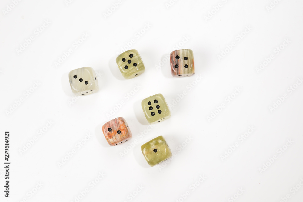 Dices made of natural stone on a white background. Copy space. Gaming.