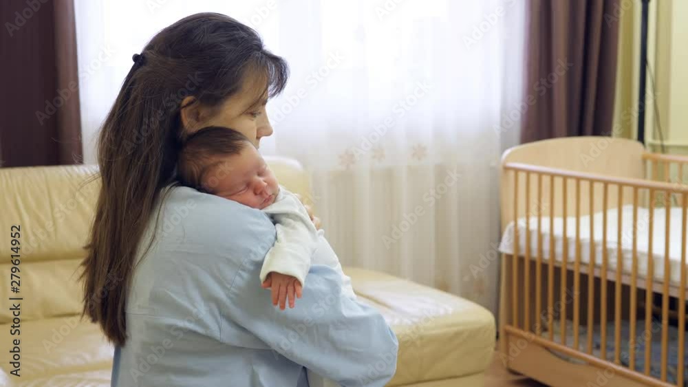 Lovely newborn baby sleeping on mother arms, carefree dreams Lovely newborn baby sleeping on mother arms, carefree dreams