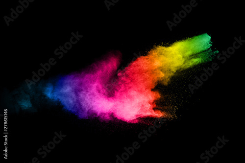 Multicolored powder explosion on black background.Color dust splash cloud on dark background.Launched colorful particles.