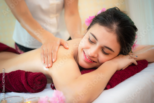 Spa Massage. Masseur doing massage with treatment sugar scrub on Asian woman body in the Thai spa lifestyle, so relax and luxury. Healthy Concept