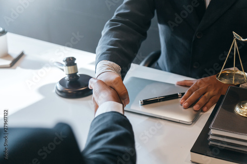 Photographie Businessman shaking hands to seal a deal with his partner lawyers or attorneys discussing a contract agreement