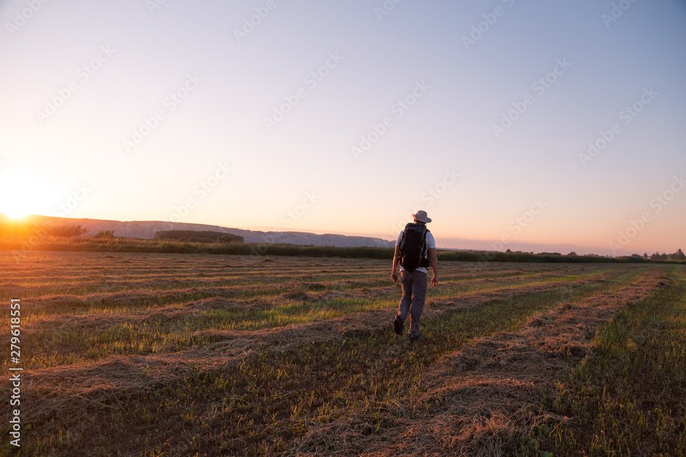 backpacker traveler walking at sunrise backpacker traveler walking at sunrise