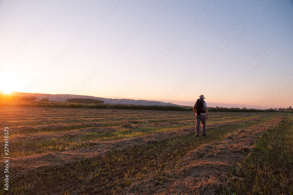 backpacker traveler walking at sunrise