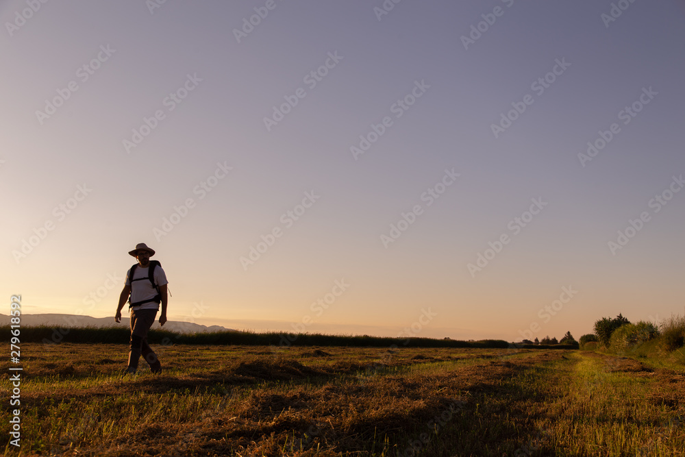 backpacker traveler walking at sunrise