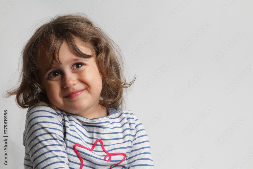 Portrait on white background of a 3-4 year old girl playing and laughing Portrait on white background of a 3-4 year old girl playing and laughing