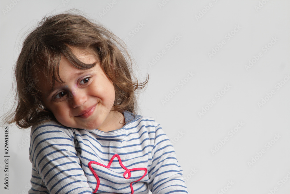 Portrait on white background of a 3-4 year old girl playing and laughing Portrait on white background of a 3-4 year old girl playing and laughing