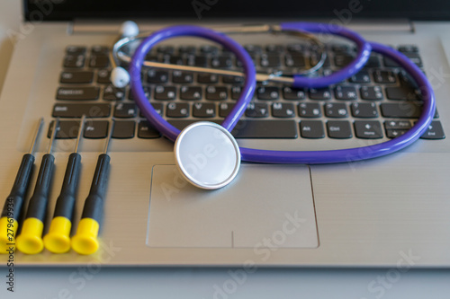 Stethoscope on laptop keyboard. Health care or IT security concept. Laptop repair concept. Computer repair concept Close-up view. Hardware