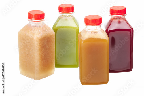 Fake fruit or vegetable juices in plastic bottles isolated on white background.