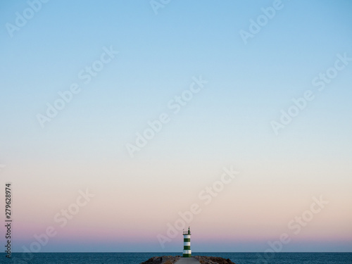 green and white lighthouse © Iago Silva