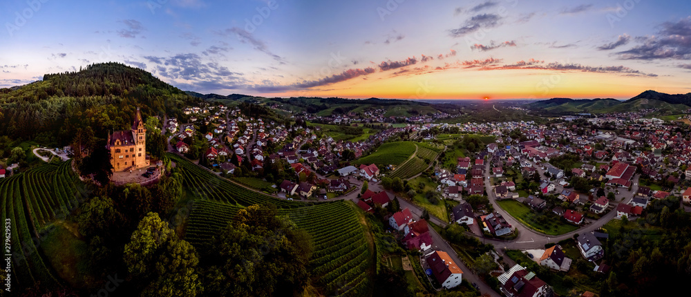 Wide hires panoramic landscape view of green valley in Schwartzwald at sunset.