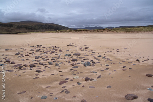 Sandwood Bay is a natural bay in Sutherland  on the far north-west coast of mainland Scotland. It is best known for its remote 1 mile long beach and Am Buachaille  a sea stack  and lies about 5 miles 