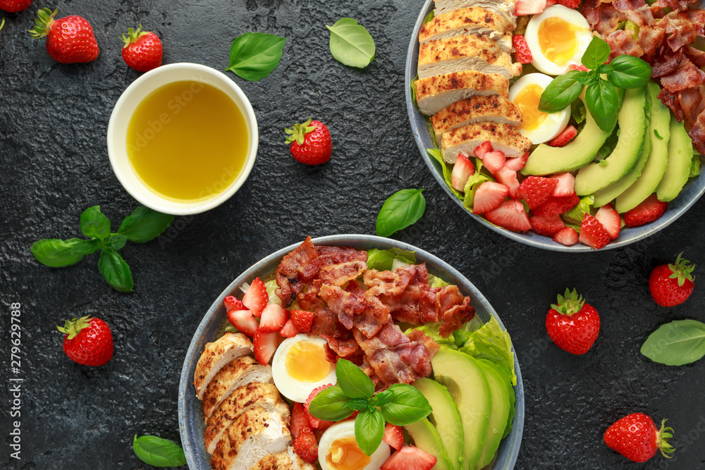 Chicken Cobb salad with strawberries, bacon, avocado and boiled eggs Chicken Cobb salad with strawberries, bacon, avocado and boiled eggs
