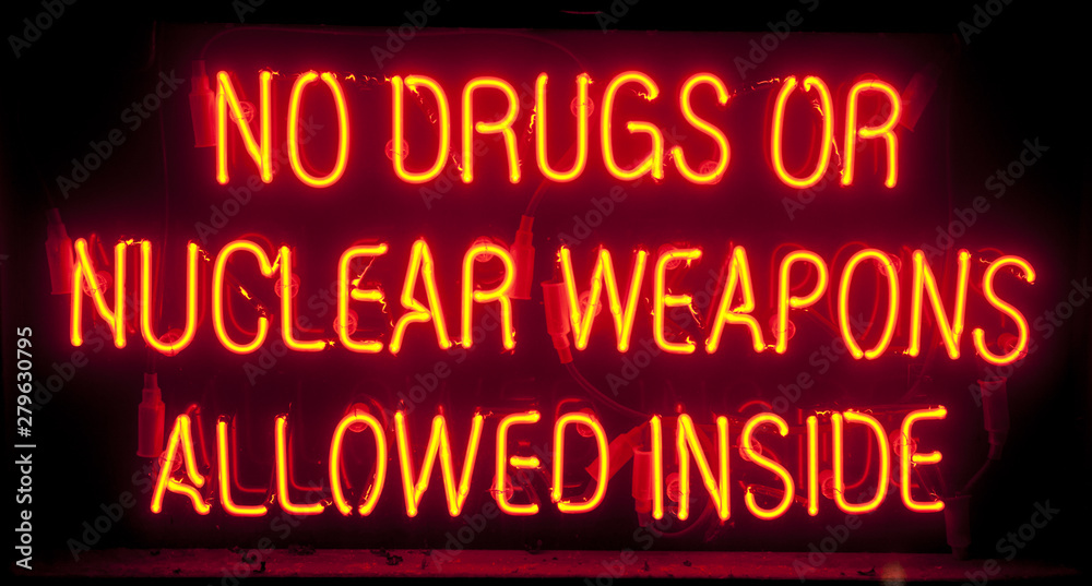 orange neon, no drugs or nuclear weapons allowed inside Stock Photo