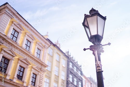 Vintage lantern against old wall in Europe. Traditional architecture of old European town.