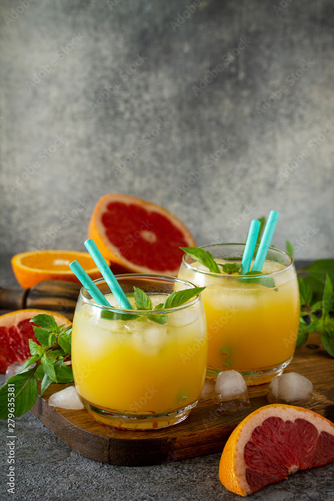 Grapefruit and orange gin cocktail or margarita, refreshing drink with ice. Free space for your text.