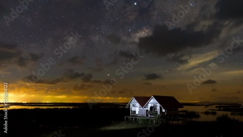 Time lapse of milky way and stars above abandoned twin house photo