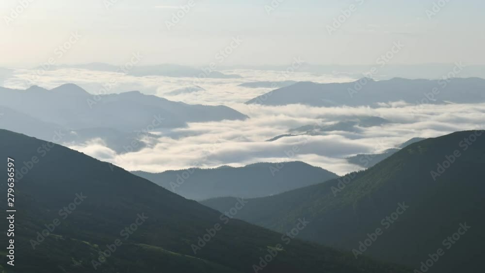 Amazing morning flowing fog in hight mountains. Ocean of clouds glowing by sunrise light. Timelapse, UHD 4K video Amazing morning flowing fog in hight mountains. Ocean of clouds glowing by sunrise light. Timelapse, UHD 4K video
