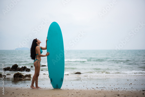 Beautiful asian sexy woman with surfboard on the beach. © ic36006