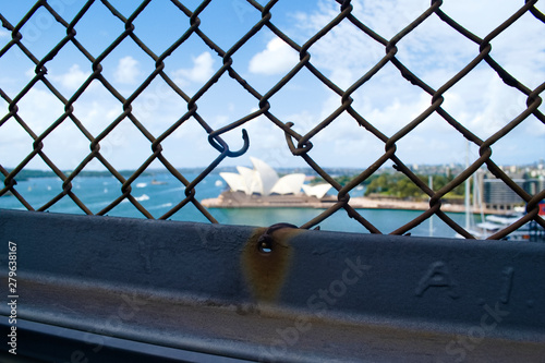 Photography SYDNEY, AUSTRALIA - Stainless steel lattice Harbour Bridge fence with the Sydney Opera House background