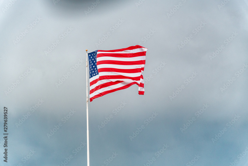 American flag waving against stormy sky American flag waving against stormy sky