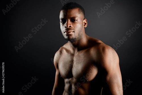 brutal handsome afro sportsman having a rest during workout in the sport center, healthy lifestyle, diet, beauty copy space