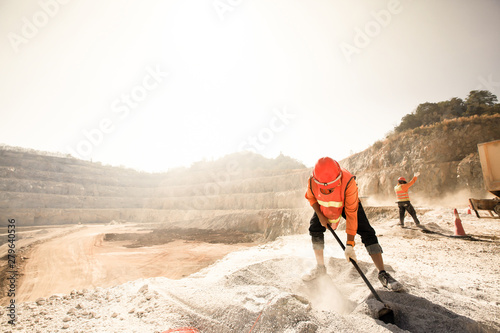 Miners working in dusty and baking hot. photo