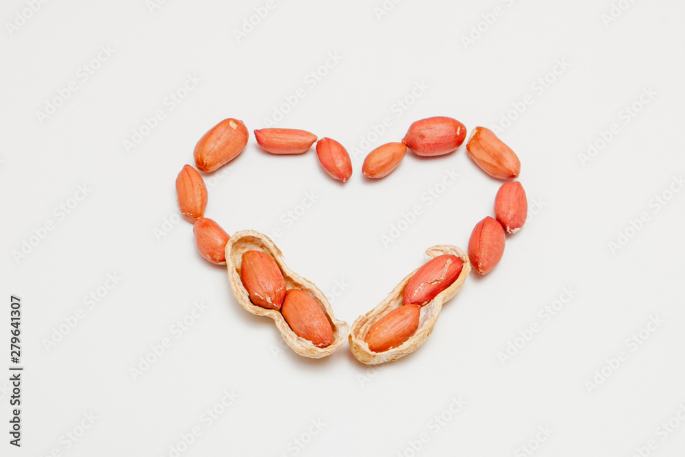 Peanuts, for background or textures. Uncleaned inshell peanuts. Peanuts isolated on white background. Valentine's Day, Flat lay. Copy space. Peanuts, for background or textures. Uncleaned inshell peanuts. Peanuts isolated on white background. Valentine's Day, Flat lay. Copy space.