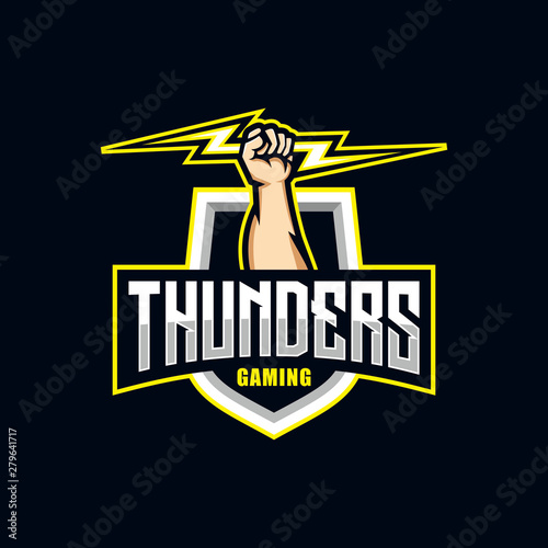 Esports Team Logo, a Powerful Hand Fist Holding a Yellow Lightning Over a Grey Shield with Thunders Text, Modern Vector Illustration for Gaming, Streaming, and Online Tournament Branding.