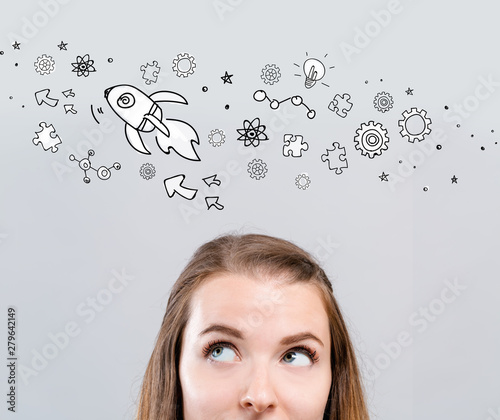 Rocket illustration with young woman looking upwards
