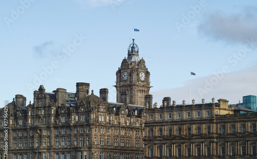 Lanscape view of the Old City of Edinburgh featuring the tower of the Balmoral Hotel on a clear day in Scotland, UK photo