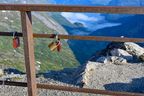 love padlocks hanging on a rail high up in the mountains of Norway photo