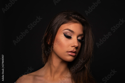 Closeup of a beautiful young woman with dark background