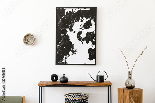 Stylish and cozy scandinavian interior of living room with wooden console, ring on the wall, cube, flowers and elegant personal accessories. Black mock up poster map. Design home decor. Template.  photo