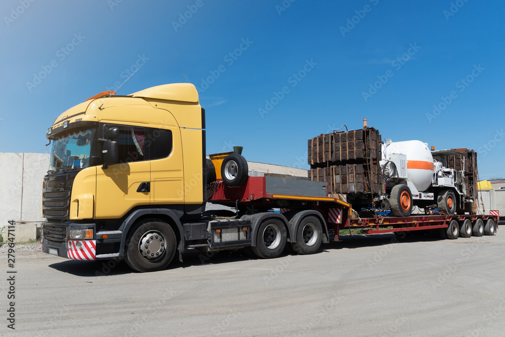 Oversized heavy transportations by truck. High industrial cargo shipped on the trawl.