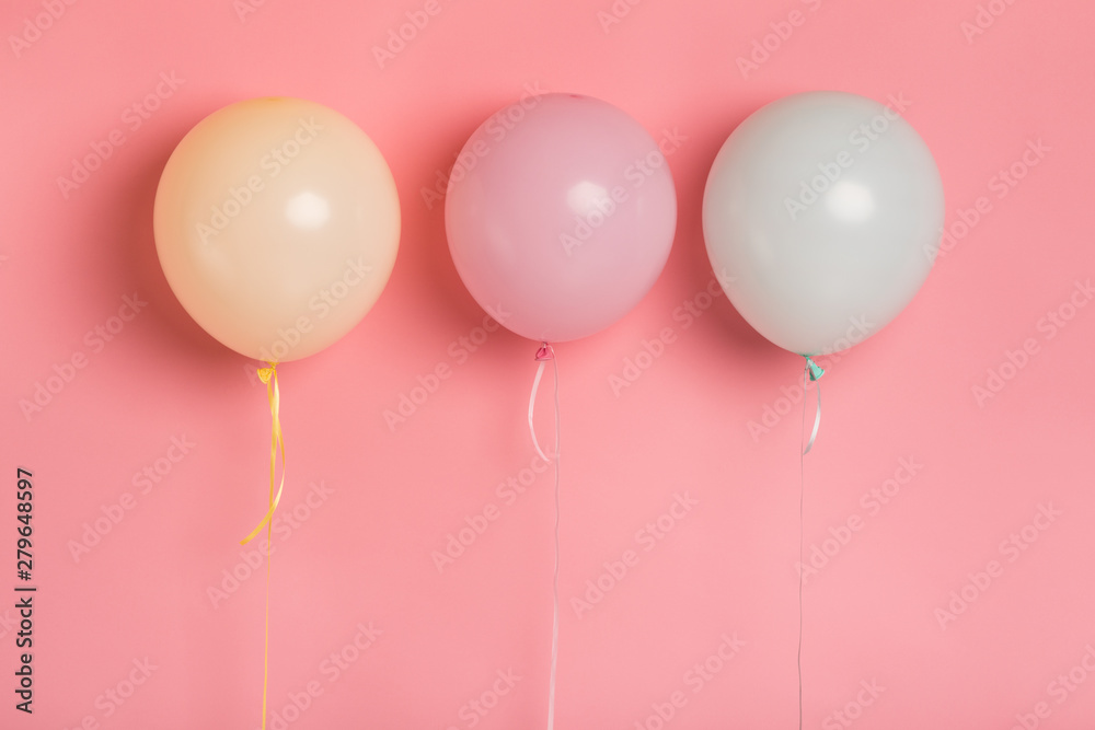 Three party balloons with blank space for advertisement on pink