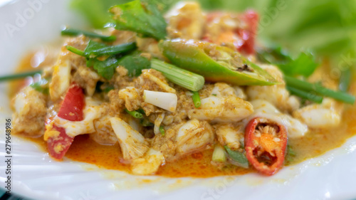 Close up of fried seafood with curry powder on white plate. (Selective focus)