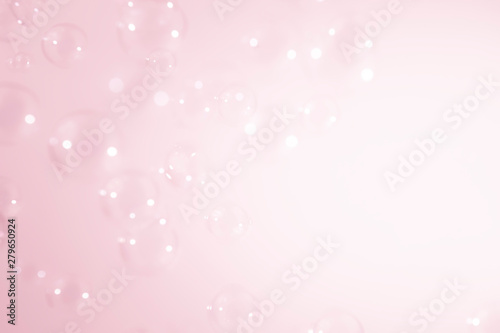 bright soap bubbles on pink background.