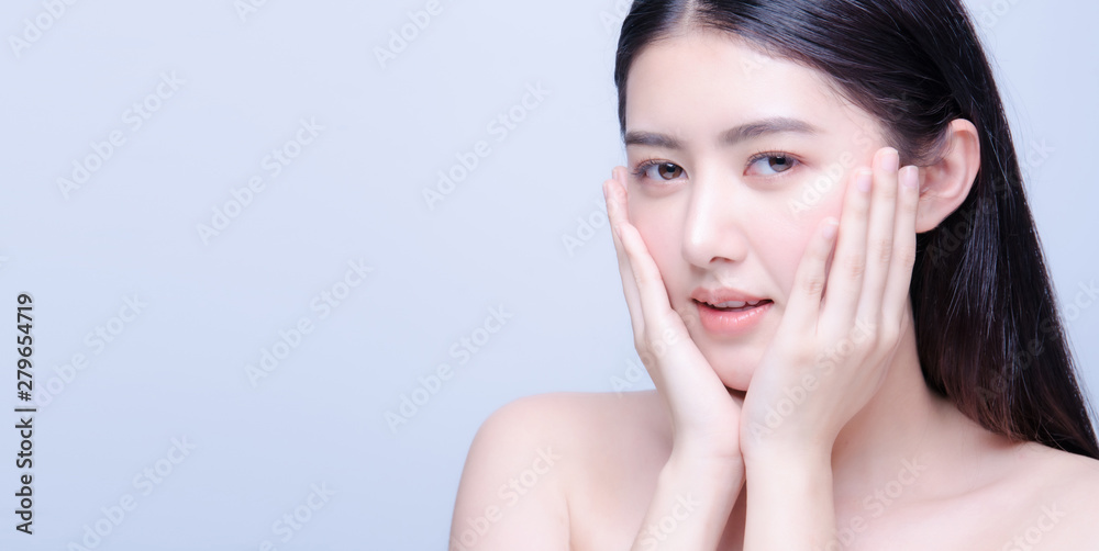 Fototapeta premium Beauty skin care asian woman smile to you isolated on blue background with shy emotional.