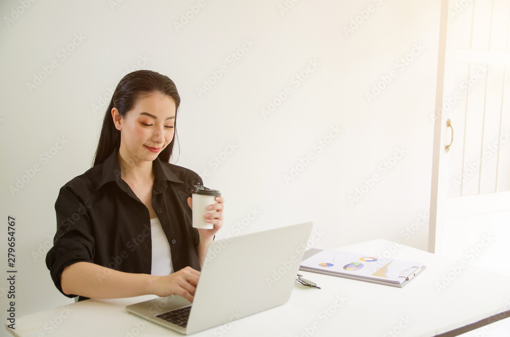 Mature successful business woman looking at laptop while at home in office work space. Mature successful business woman looking at laptop while at home in office work space.