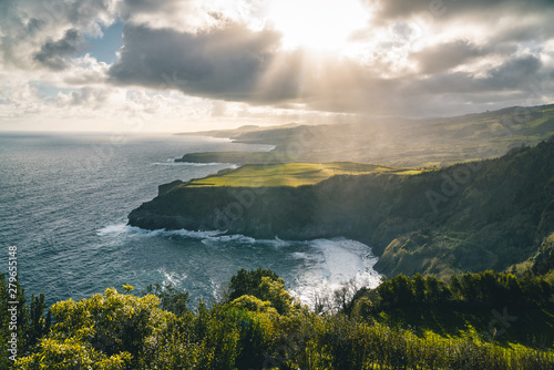 Epic scenic outlook of Miradouro de Santa Iria - north coast of Sao Miguel, largest island of Azores archipelago during sunset with dramatic sky and clouds.