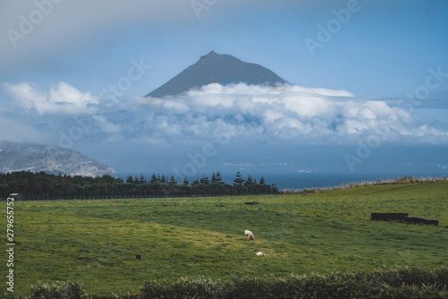 Pico Island, Azores, Portugal, with a view to Pico Mountain and wine culture between clouds during Sunset.