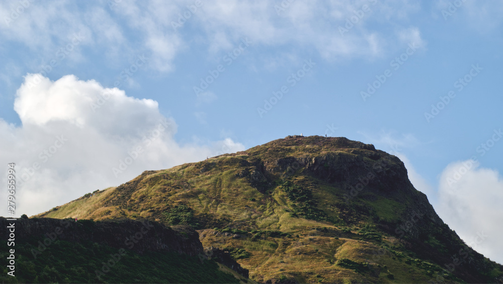 Arthur's seat in Edinburgh, Scotland, UK on a sunny day in the summer with clouds in the background