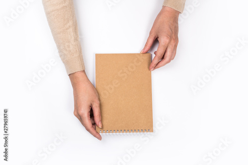 Woman's hands with perfect manicure holding notepad as mockup for your design. White background, flat lay style.