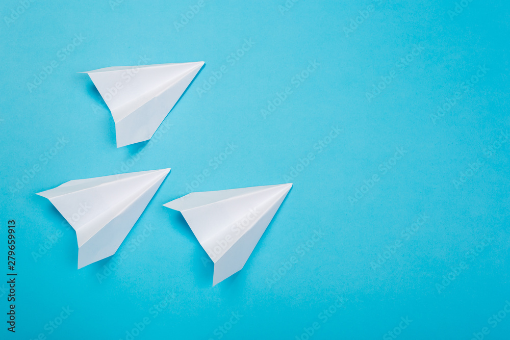 white paper airplane on a navy paper background white paper airplane on a navy paper background