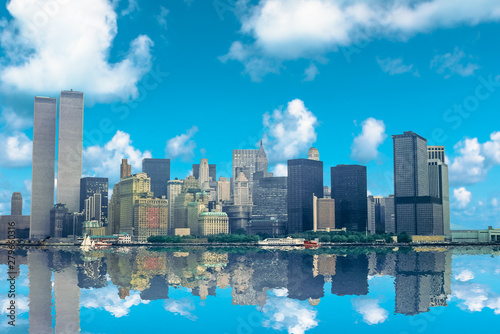 Amazing skyline of Manhattan reflecting over Hudson River on a beautiful sunny day. Archival and historical cityscape of New York Twin Towers of World Trade Center. NYC, United States.