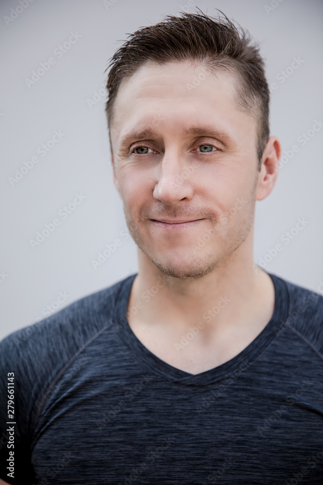 Fototapeta premium Sporty man in gray t-shirt portrait