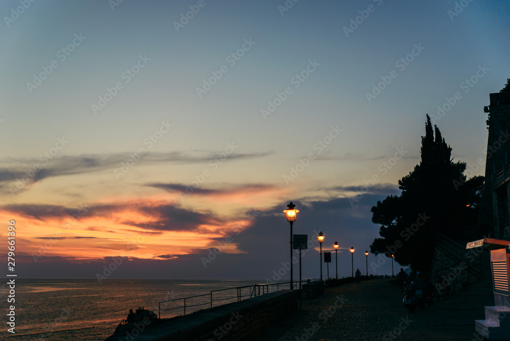 park view with city lights lamps sea on background in rovinj city in croatia