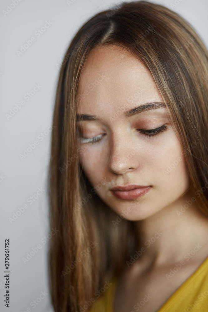 woman eats bad unhealthy food. girl with a spot on her face looking down,close up photo. isolated white background. unhealthy lifestyle