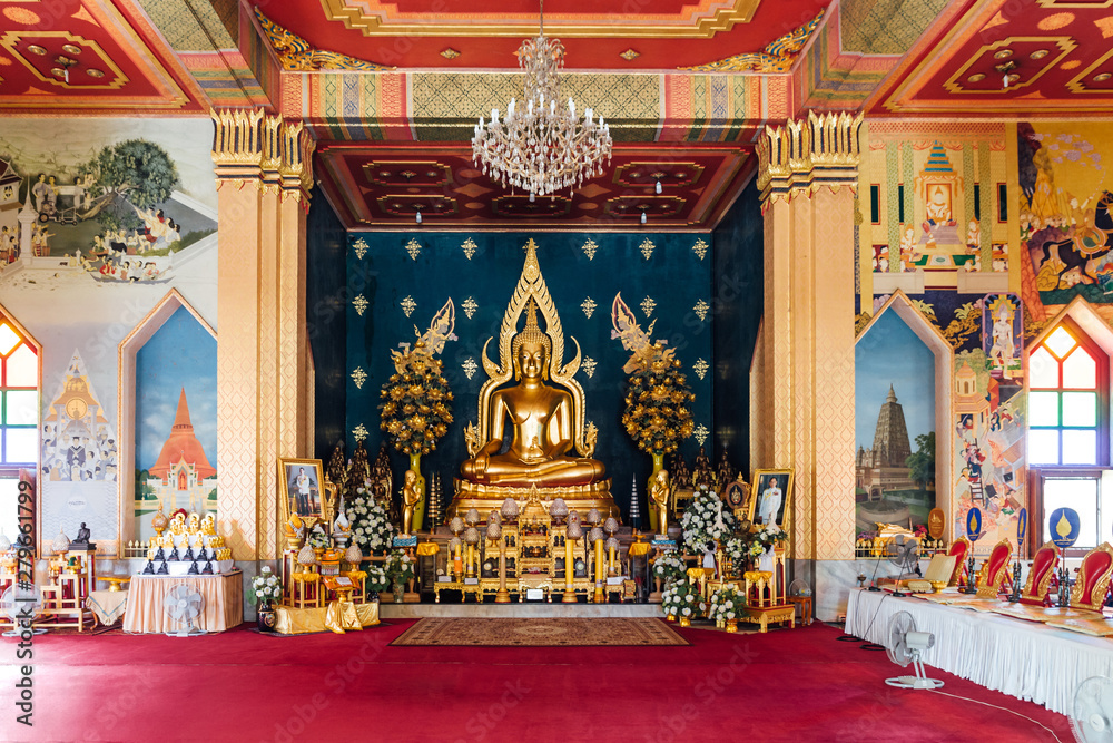 Interior of Thai Monastery (Thai Temple) decorated with Thai art and Golde Lord Buddha Statue in the center at Bodh Gaya, Bihar, India.